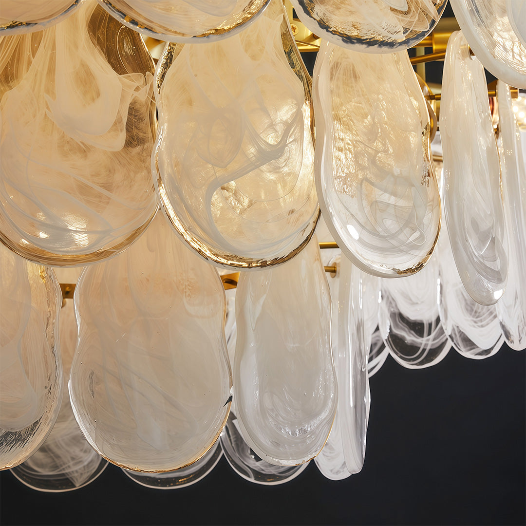 Chandelier above a curved sofa