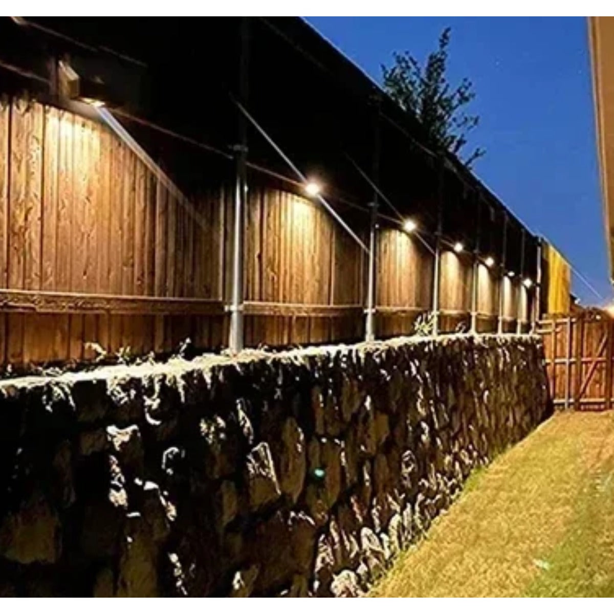 Solar wall lights on stone fence