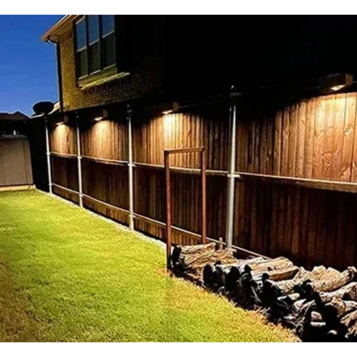 Solar wall lights on garden fence