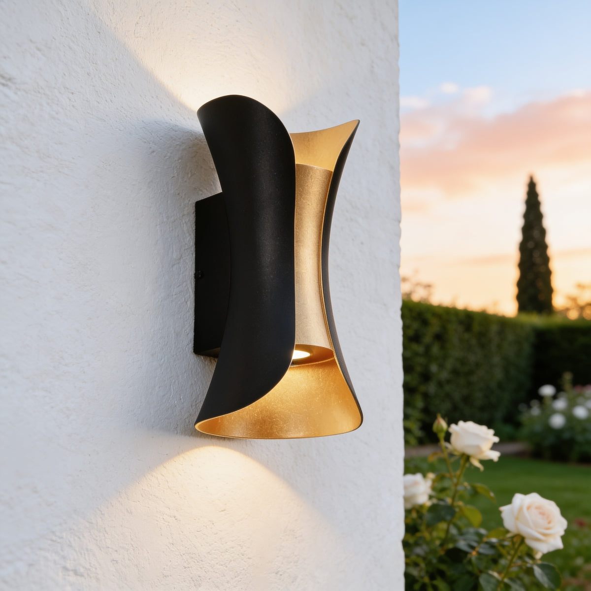 Curved Up and Down Wall Light in black and gold on a white stucco wall