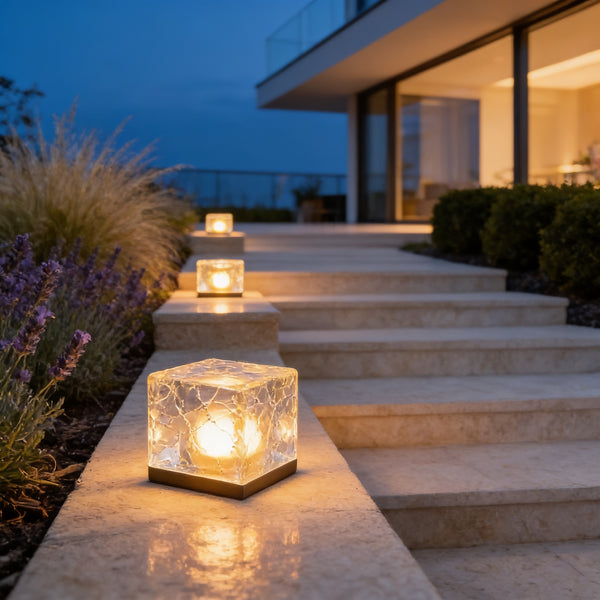 Warm white Ice Cube Step Lights glowing on limestone garden steps