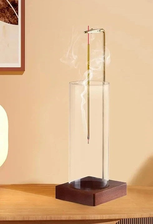 Incense stick holder with glass ash catcher on a side table