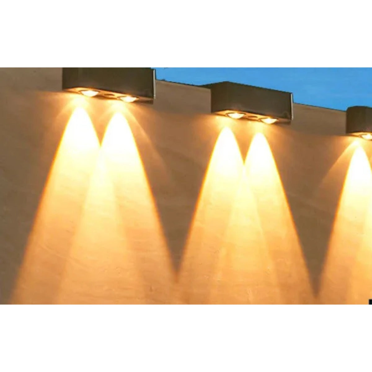 Solar wall spotlights glowing warm