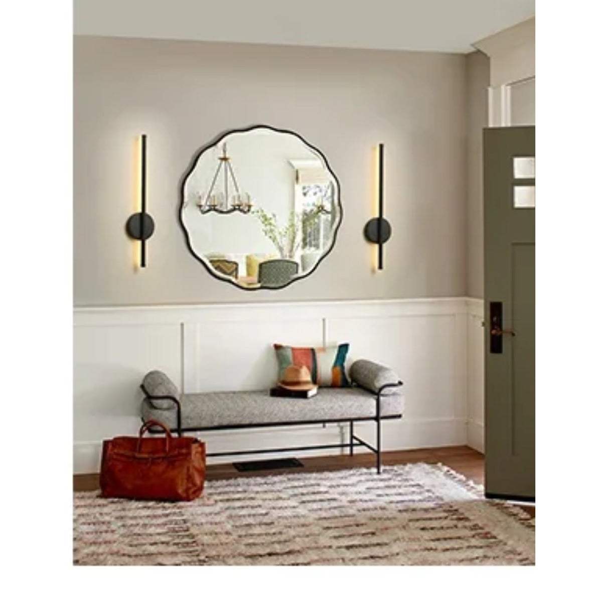 Sconces beside entry mirror