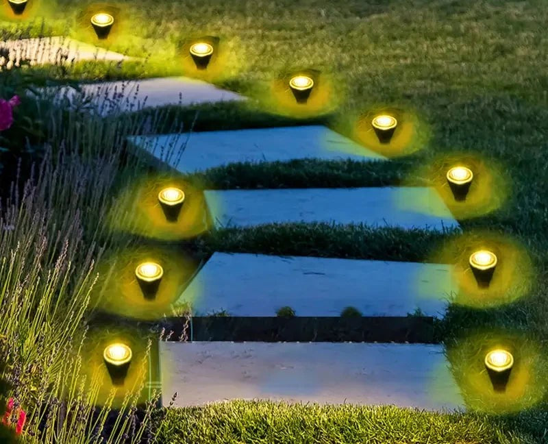 Warm white solar lights along stone garden steps at night