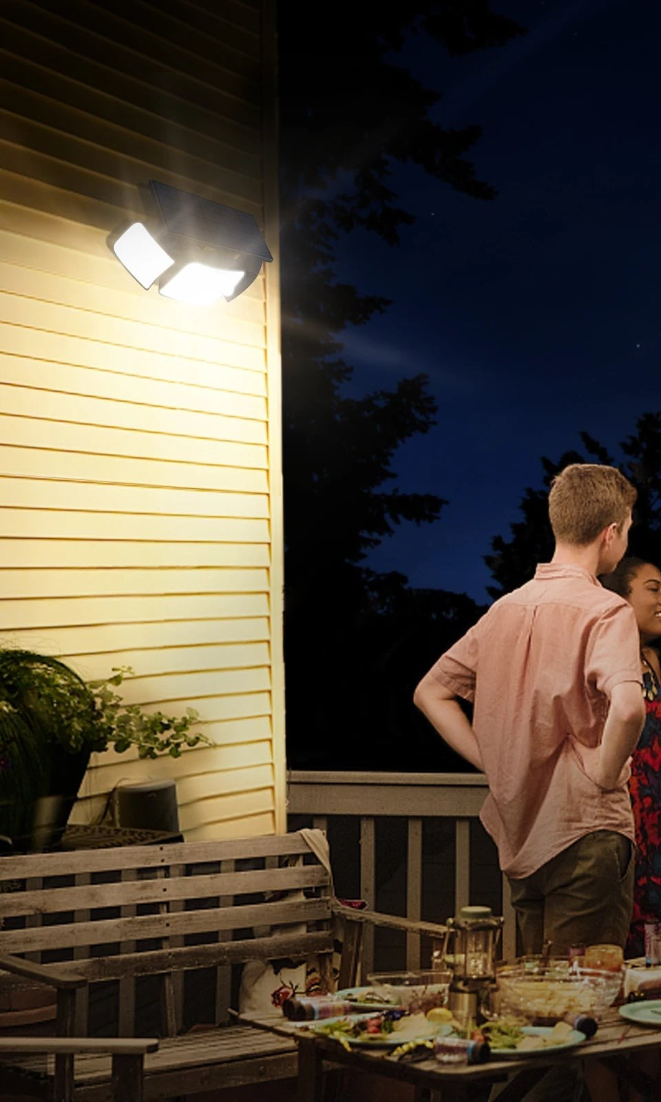 Solar flood light over a deck during an evening gathering