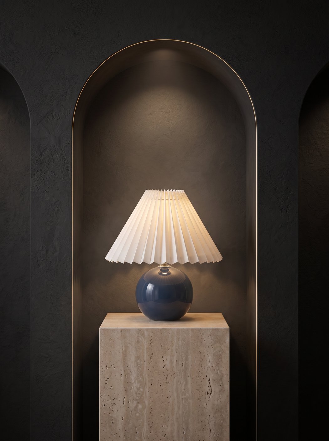 Pilar pleated table lamp in a dark arched alcove