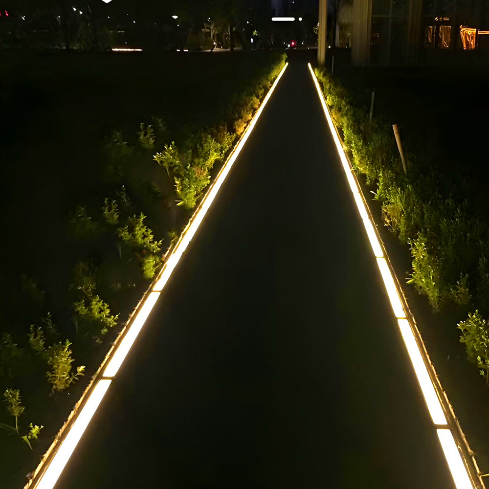 Pathway at night lined with continuous warm LED light strips